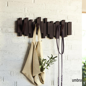 Umbra Sticks retractable pegs coat hanger offering flexible storage for coats and bags.