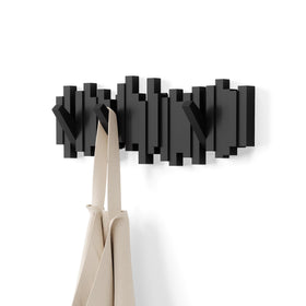 Umbra Sticks wall-mounted coat rack rail for a sleek, space-saving entryway.