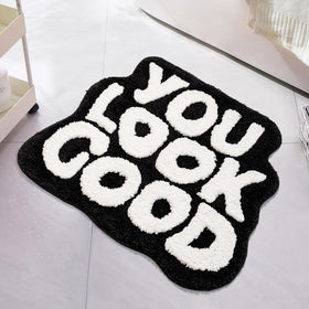 UNIBATH You Look Good bath mat top view in black-and-white design for chic bathroom decor