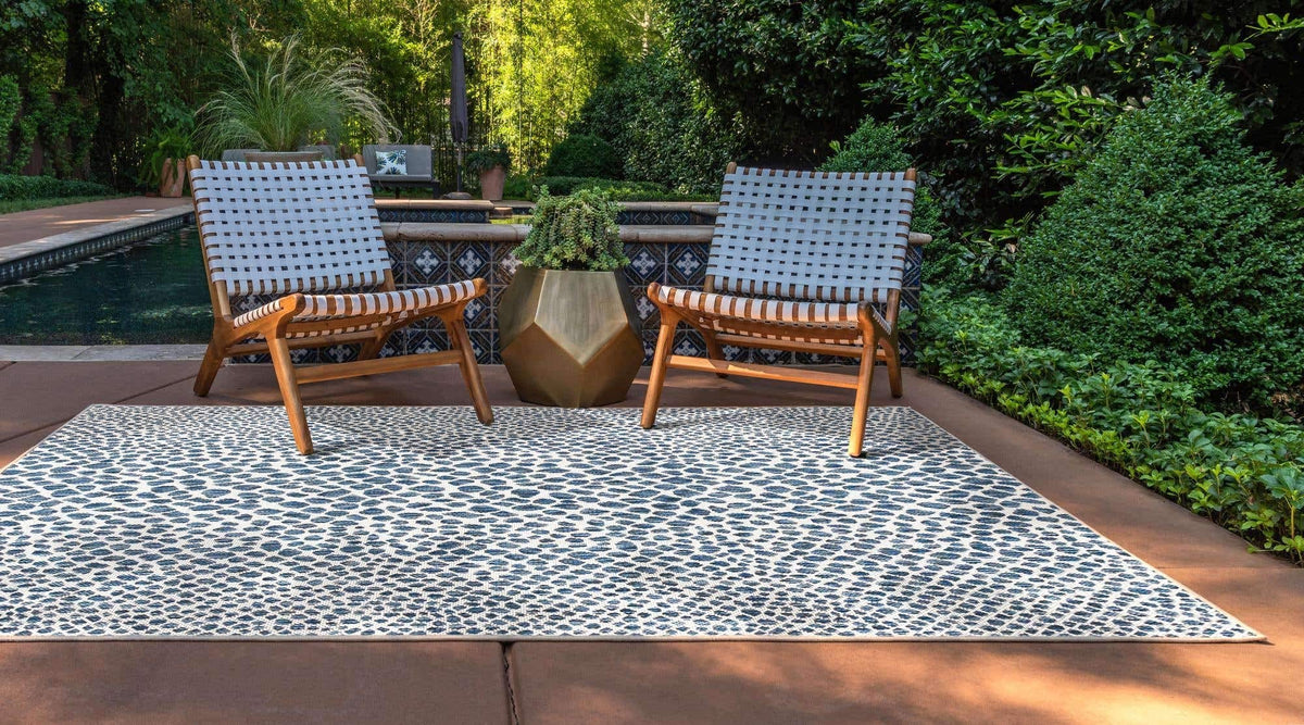 Unique Loom Cape Town outdoor rug blue olive; patio setting emphasizes versatile outdoor use.