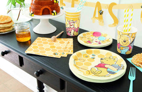 Unique Winnie the Pooh table setting display shows a coordinated party look.