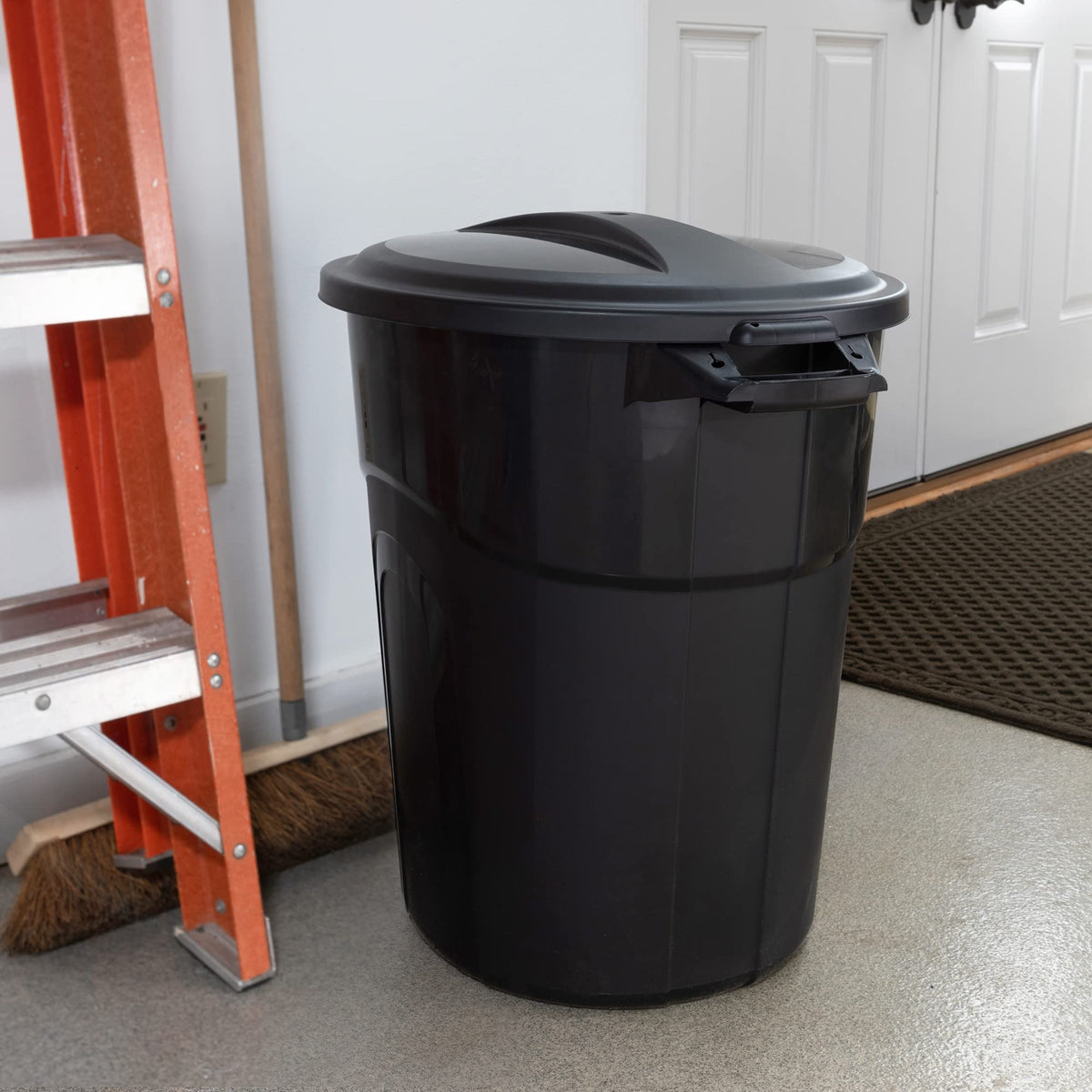 United Solutions black round bin stores waste discreetly in tight spaces.