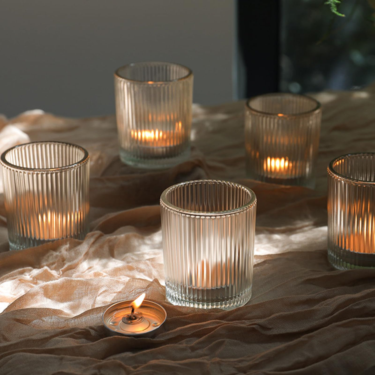 Uniteland votive candle holders in clear glass enhance ambiance as a wedding centerpiece.
