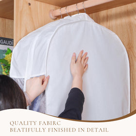 Univivi white cotton garment bag protecting jackets and dresses while hanging.