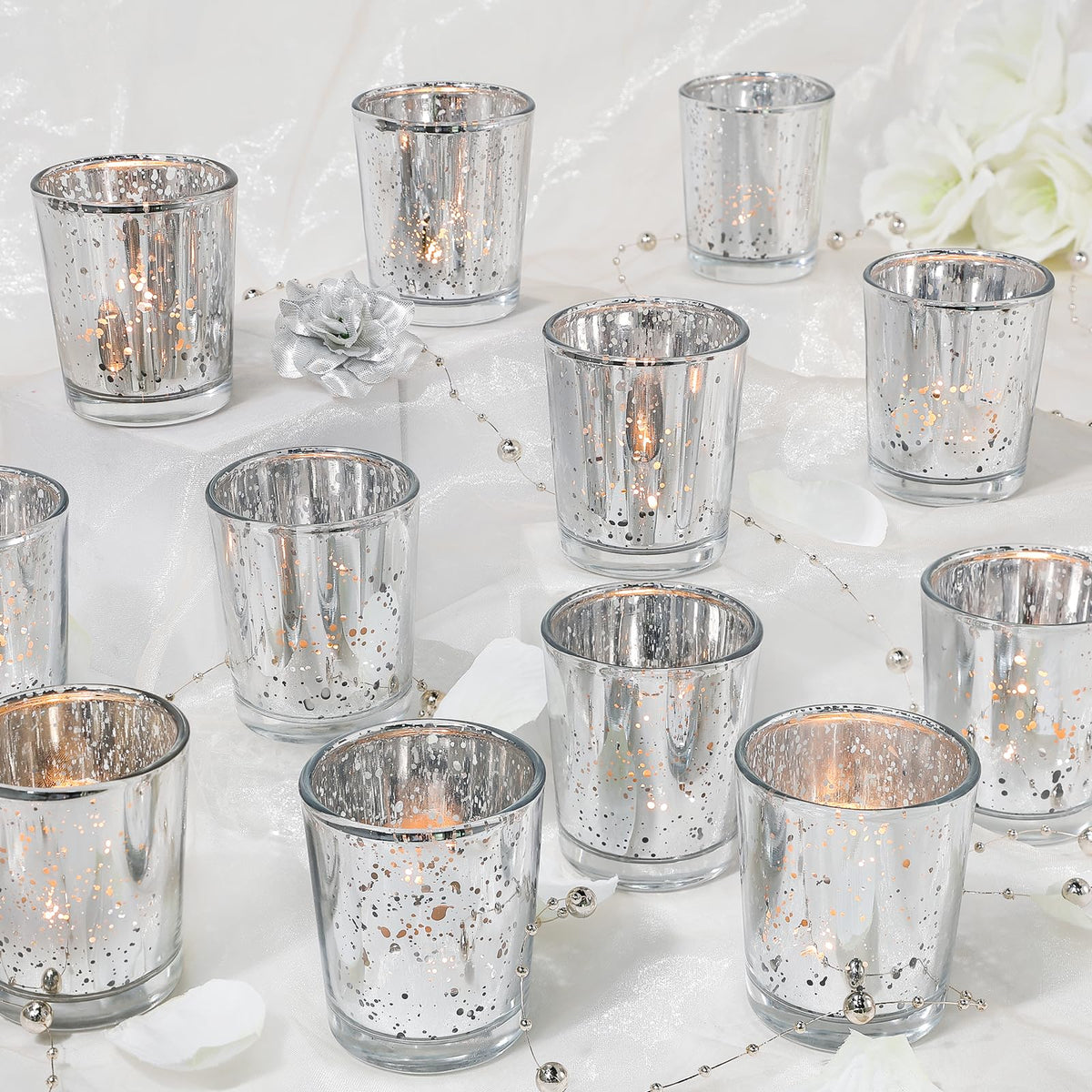 UPBUD votive candle holders 24-piece set beams warm ambience with speckled mercury glass.