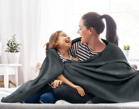 Folded Utopia Bedding blanket in smoke gray highlighting lightweight breathable cotton