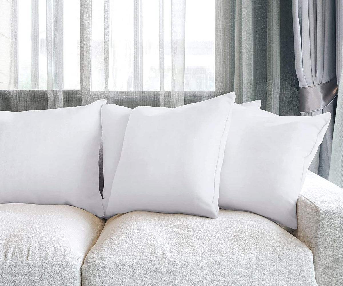 Utopia Bedding 20x20 inch pillows arranged on a neatly made bed.