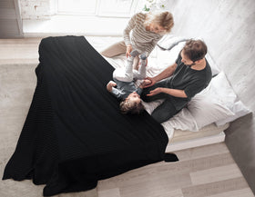 Utopia Bedding all-season blanket draped over sofa for cozy living room vibes.