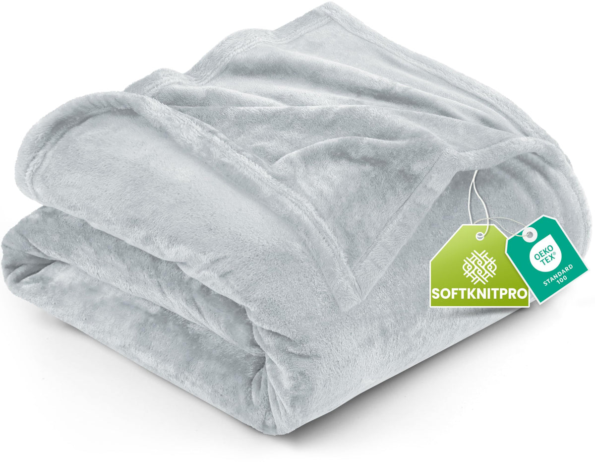 Utopia Bedding fleece blanket on queen bed showing plush microfiber softness for all season warmth.
