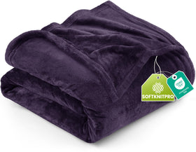 Utopia Bedding fleece blanket on bed in purple demonstrates all-season warmth.