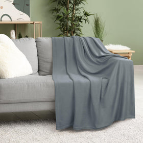 Utopia Bedding knit blanket on an armchair demonstrates drape and comfort.