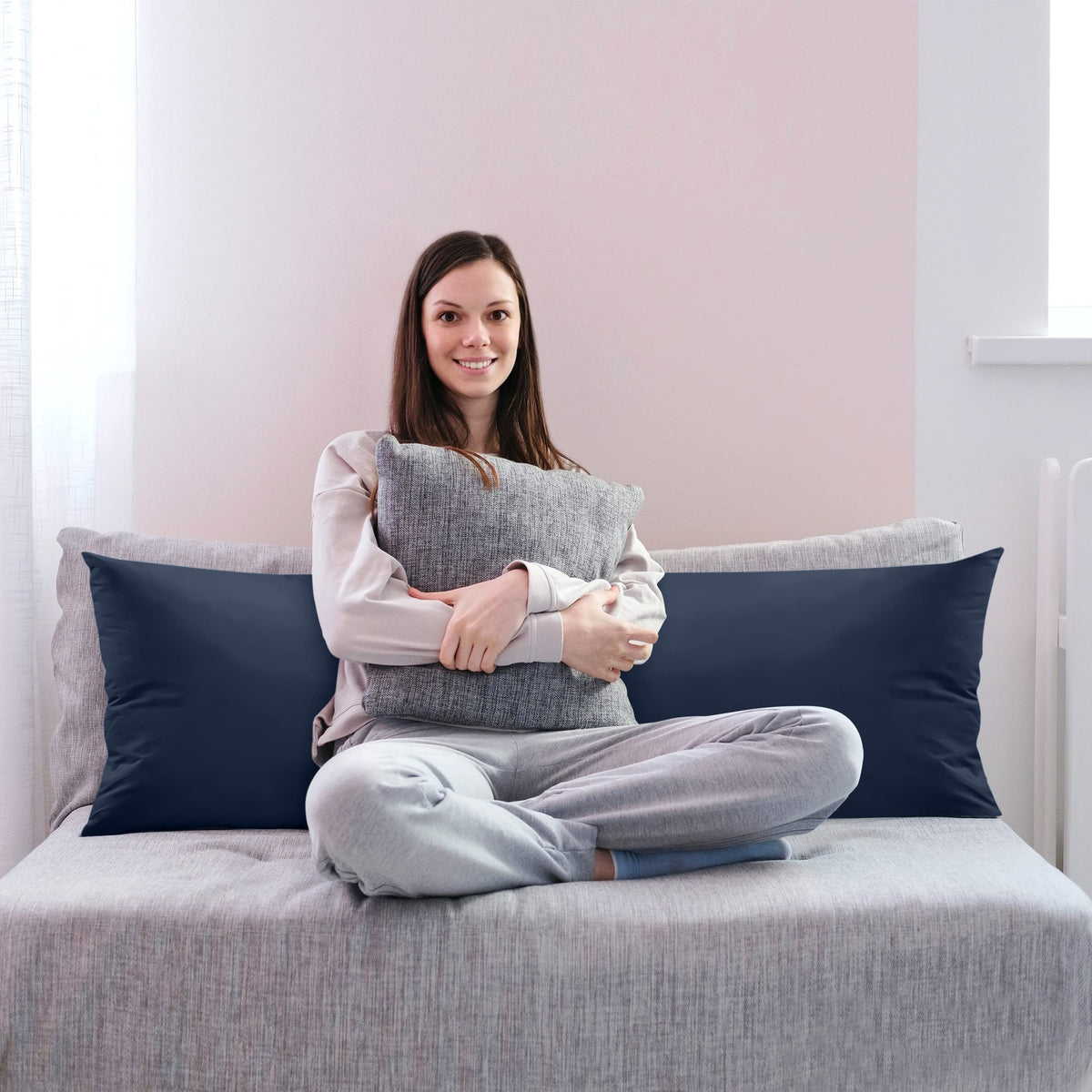 Long pillow on bed demonstrating extended length.