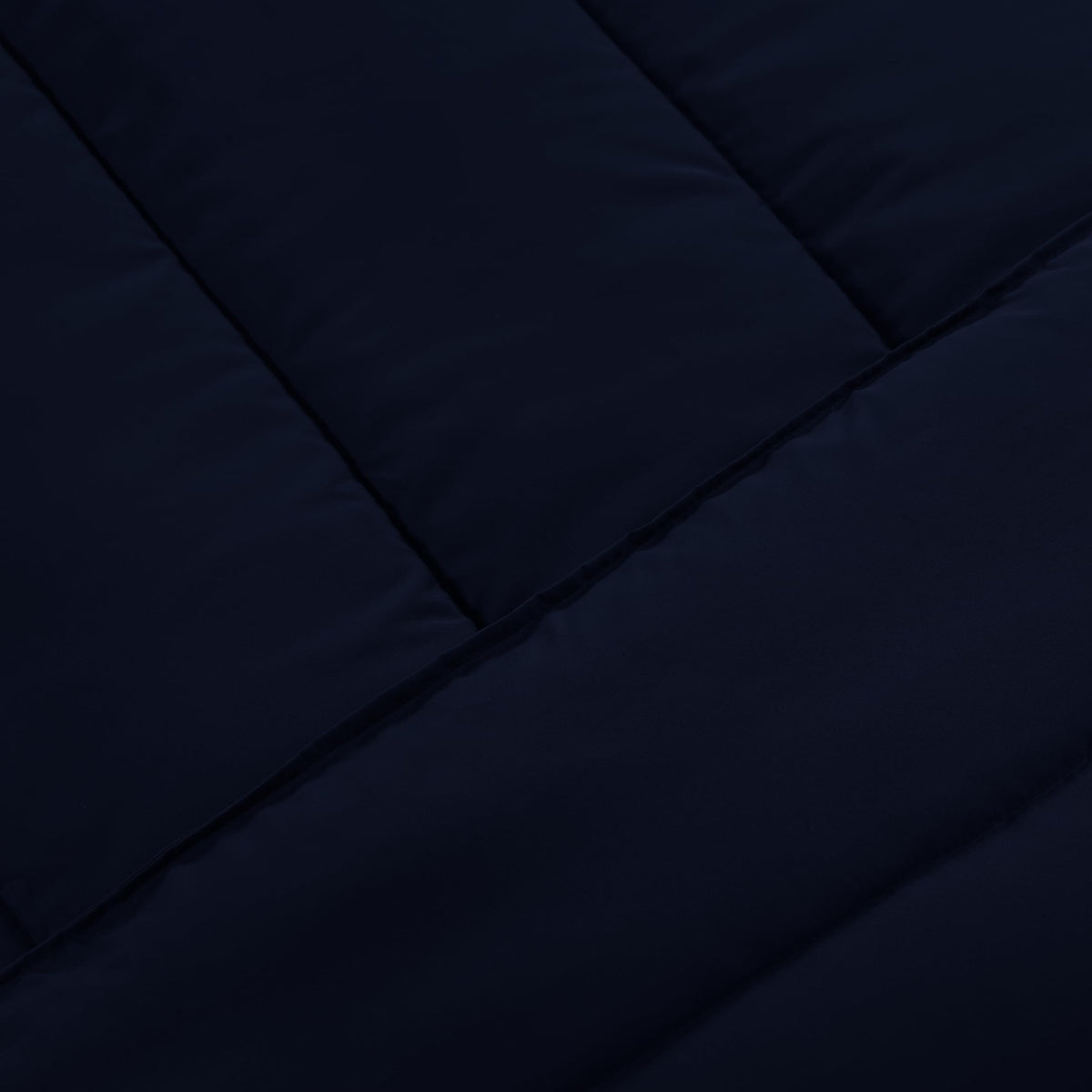 Utopia Bedding Navy lightweight bedding laid on a bed for year-round comfort.