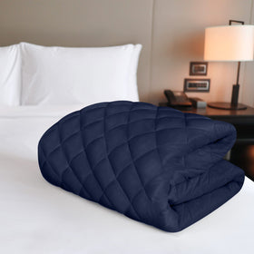 Utopia Bedding quilted mattress pad in navy bedroom setup enhances comfort and cleanliness.