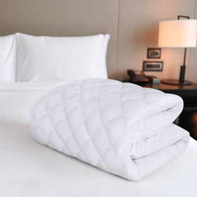 Utopia Bedding quilted mattress pad white texture adding softness to bed.
