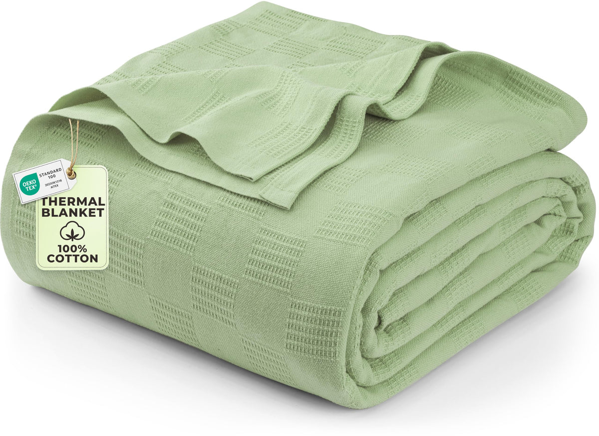 Utopia Bedding sage green thermal blanket on sofa provides breathable warmth and stylish living room decor.