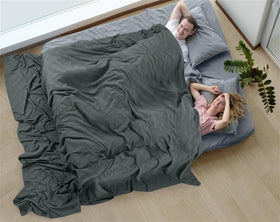 Utopia Bedding thermal blanket on a couch setting showcasing neutral smoke gray