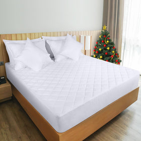 Utopia Bedding white king mattress pad laid on a made bed.