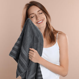 Utopia Towels hanging in bathroom scene showcase plush shade and warmth.