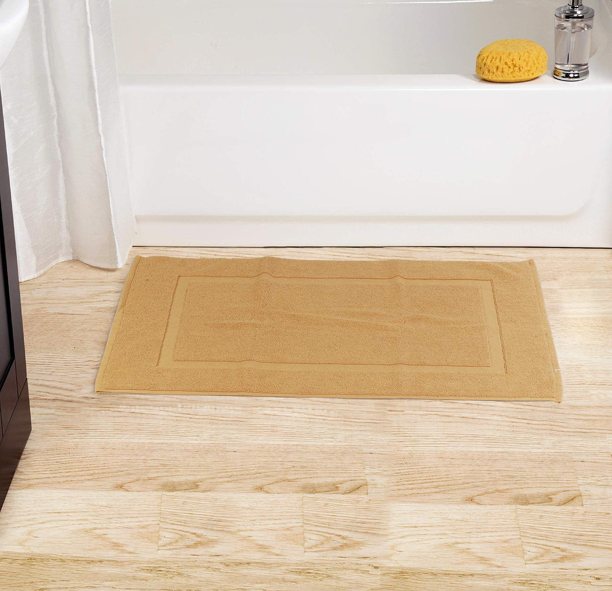 Bath mat by shower entry from Utopia Towels for tidy spaces.