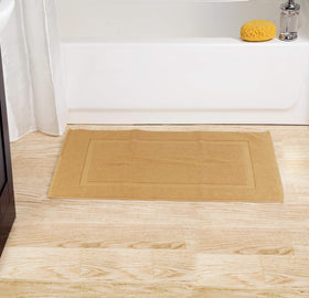 Bath mat by shower entry from Utopia Towels for tidy spaces.