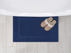 Utopia Towels roomy 21x34 mat placed by a shower.