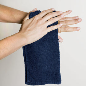 Utopia Towels washcloths neatly stacked for organized guest bathroom setup.