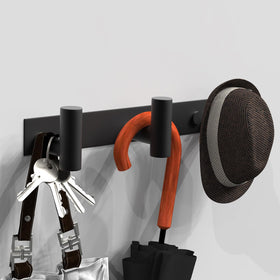 Close-up of VAEHOLD towel hanger showing space between hooks for ventilation.