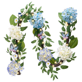Valery Madelyn 6ft garland on mantle with blue-white hydrangeas and butterflies.