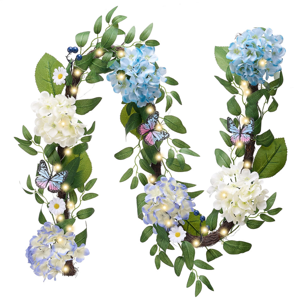 Valery Madelyn 6ft garland on mantle with blue-white hydrangeas and butterflies.