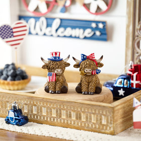 Valery Madelyn Highland cow figurine with stars for festive decor.