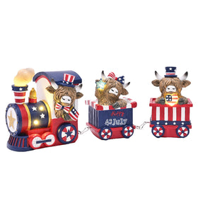 Valery Madelyn Highland cow train with flag for year-round patriotic displays