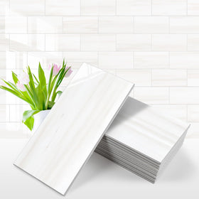 Vamos Tile glossy dolomite white 3x6 backsplash closeup shows a durable, high-shine surface.