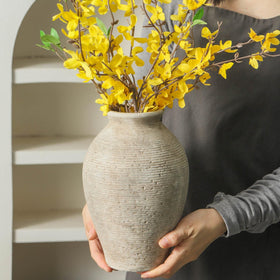 Vanselia vase displayed as a dining room centerpiece with flowers