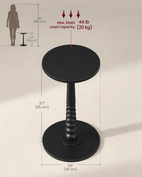 MARIEL ink-black round table showing its minimal, mid-century profile.