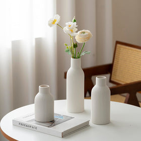 VAURCESA 8-inch white ribbed vase suits compact floral arrangements.