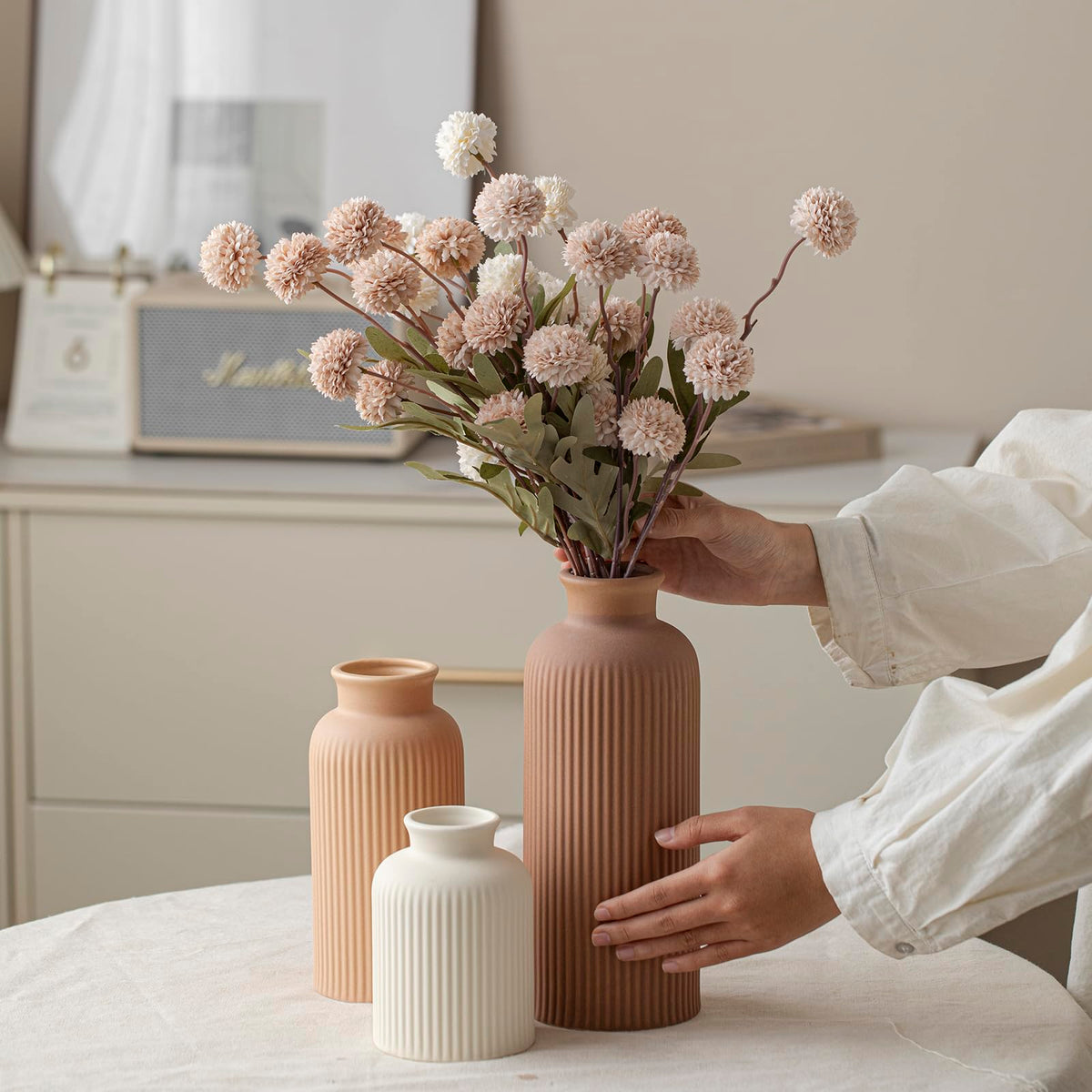 Vaurcesa light terra-cotta vase set introduces warm hues to shelves and tables