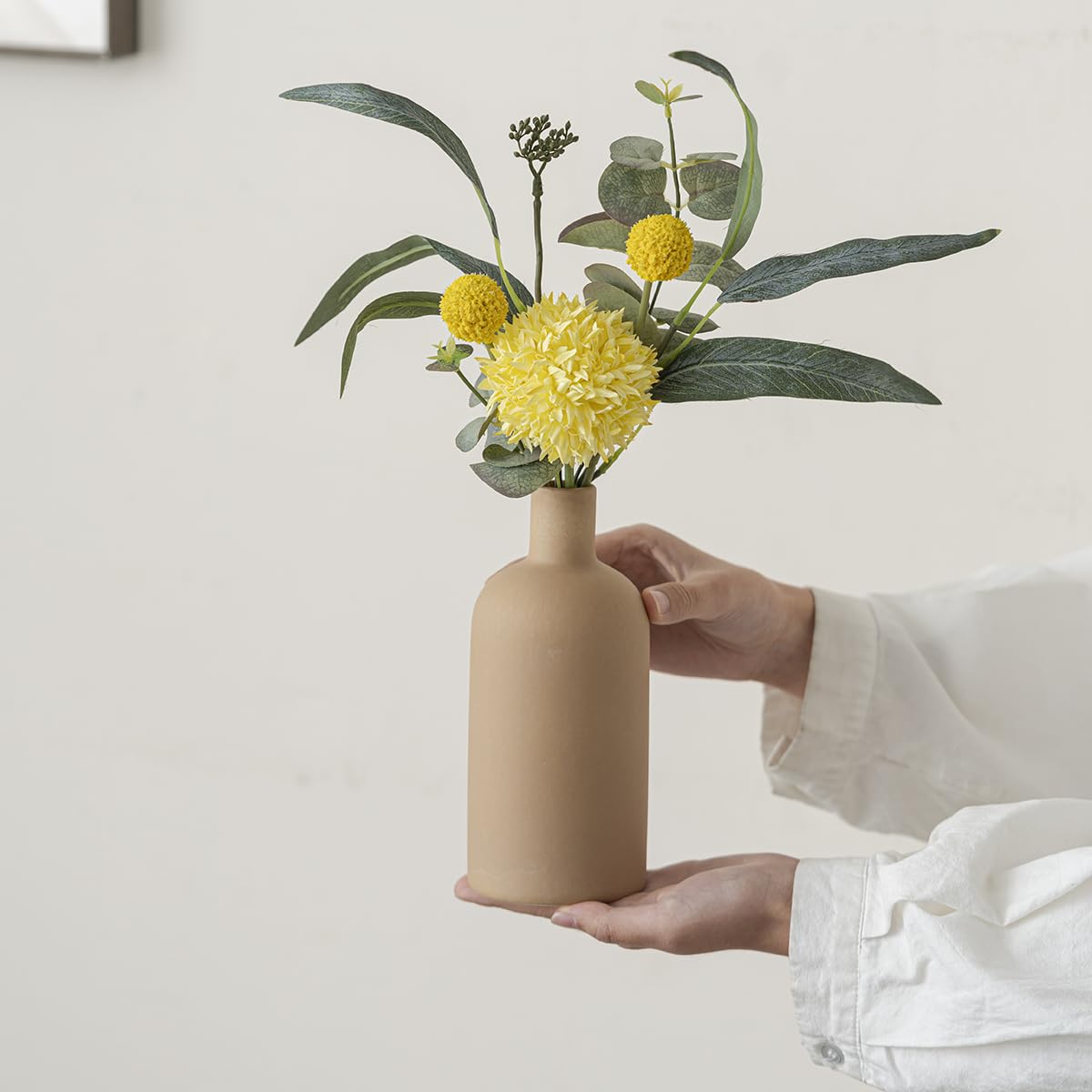 Vaurcesa mantel display using minimalist ceramic vases as sculptural accents
