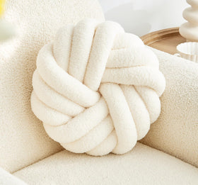 Vdoioe knot pillow in cream white round shape adds soft comfort to sofas.