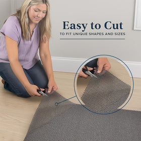 Rug pad underlay on hardwood floor demonstrates open grid for airflow.