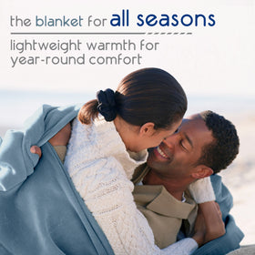 Vellux Original Queen blanket on sofa for lightweight all-season warmth.