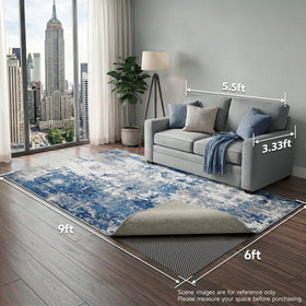 Dark-grey Veken rug pad gripper in use on a tiled floor for safety.