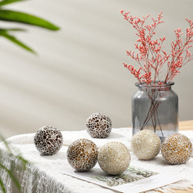 Vesici mosaic sphere white brings clean contrast to bowls and vases.