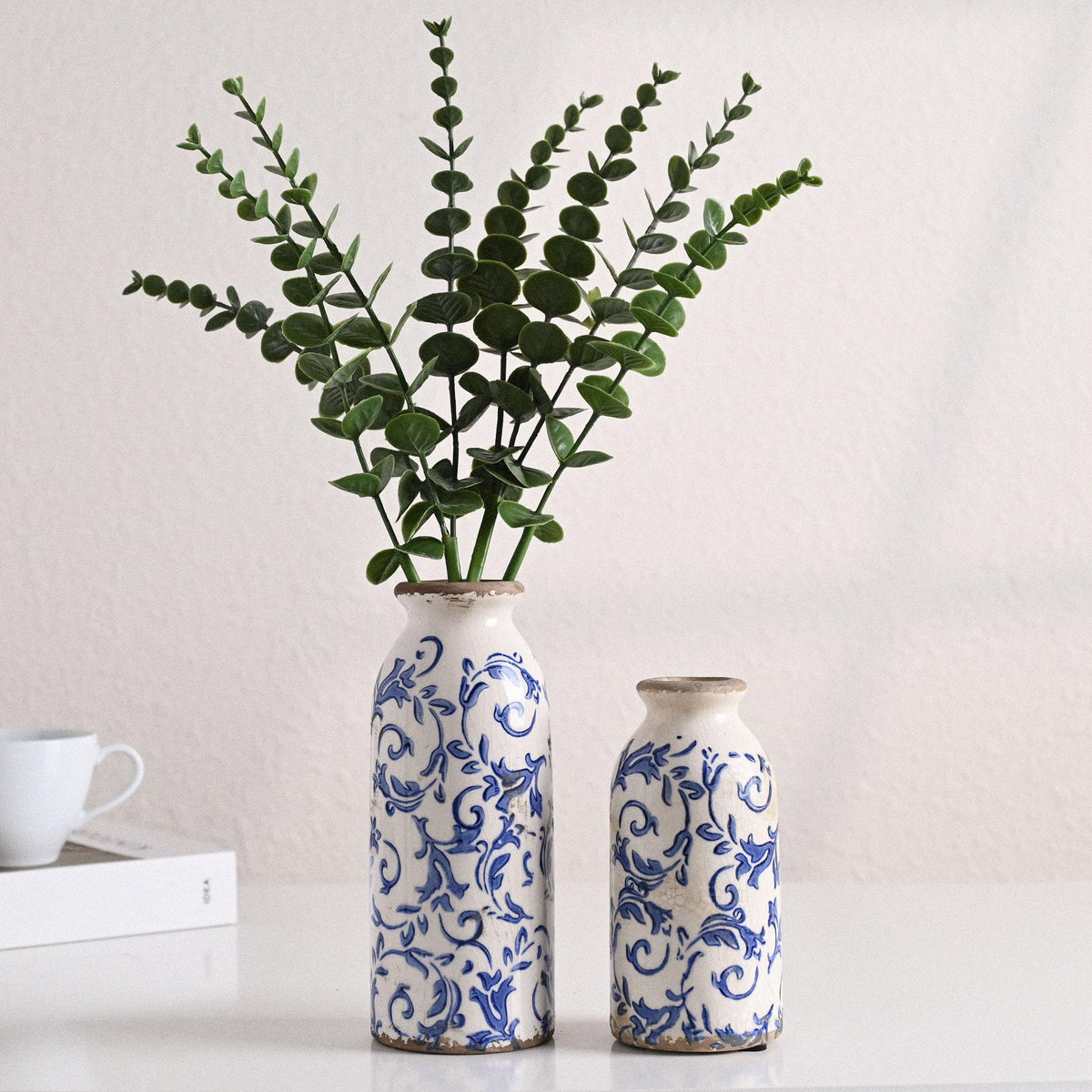 Victor & Teresa blue-white ceramic vase close-up glaze highlights artisan texture.