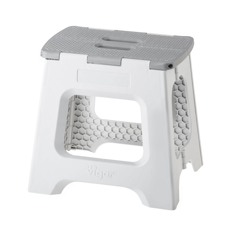 Vigar compact folding stool closed, space-saving storage beside cabinets