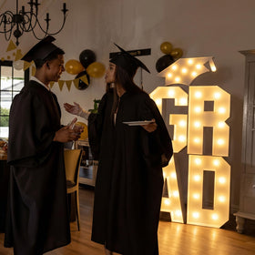 VIHOSE LED marquee grad letters glow to enhance evening celebrations.