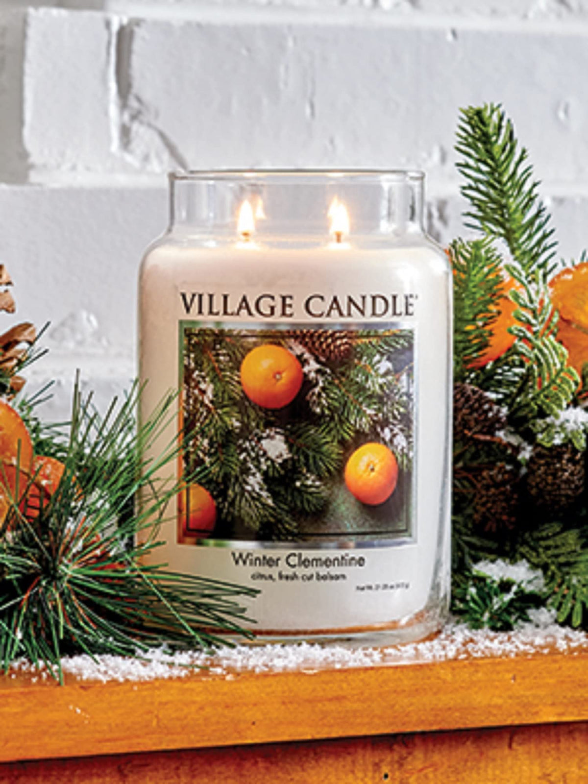 Village Candle Winter Clementine jar on table evokes cozy home scent.