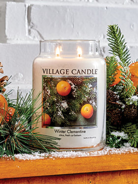 Village Candle Winter Clementine jar on table evokes cozy home scent.
