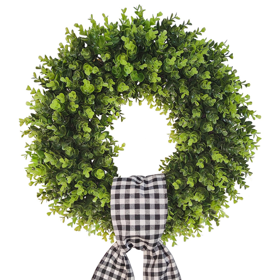 Vofuly boxwood wreath with buffalo sash graces the front door for year-round curb appeal.
