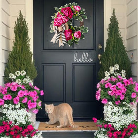 Vofuly door decor on porch demonstrates a welcoming focal point for guests